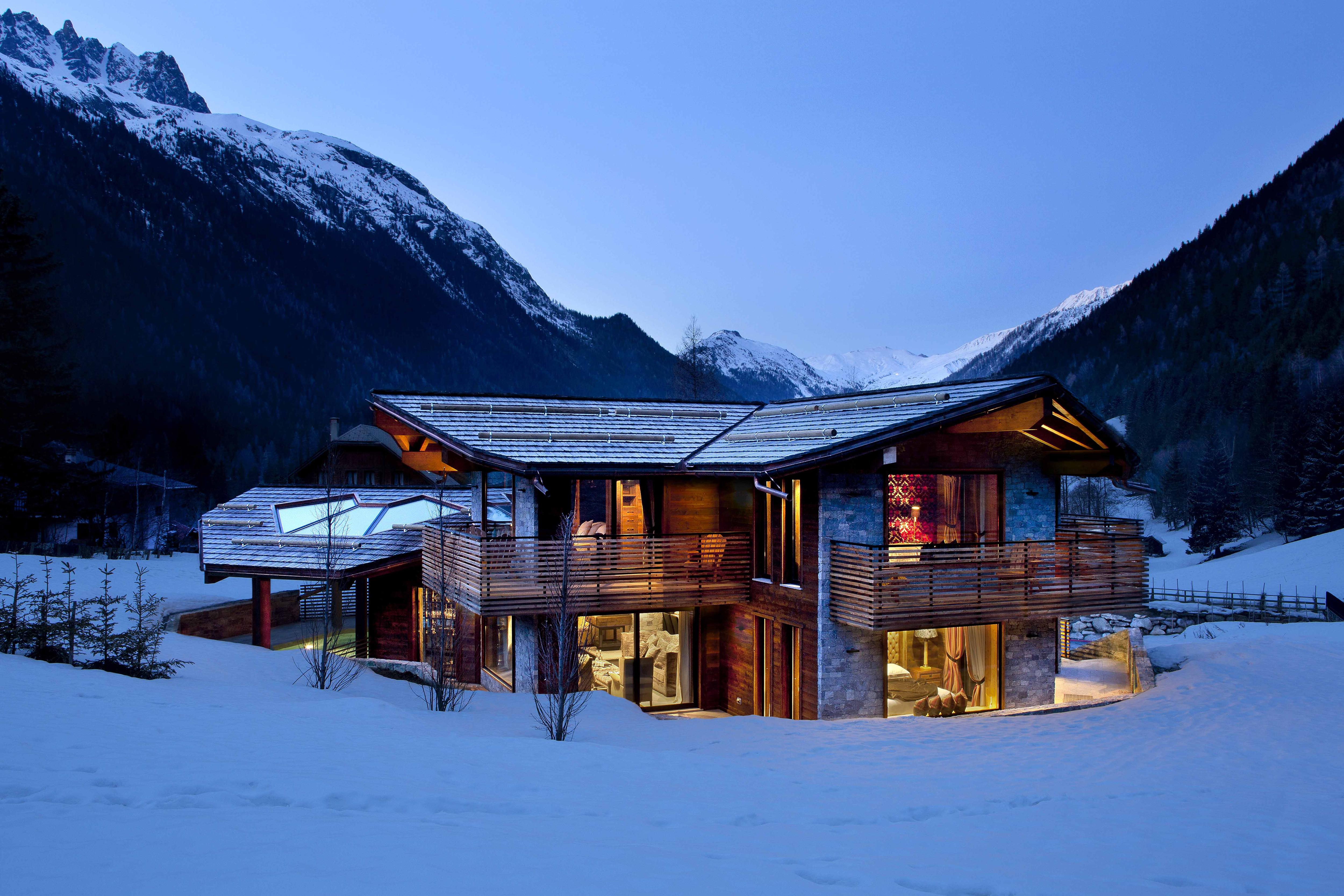 Luxury ski chalet in the French Alps with the snow-topped mountains in the distance