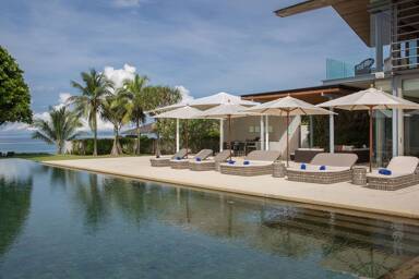 Aerial view of 39-bedroom beachfront estate on Natai Beach, Phuket, with multiple swimming pools and direct beach access