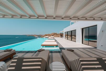 Under the pergola at Diaz Grande with views of the infinity pool and the  Aegean Sea that surround it