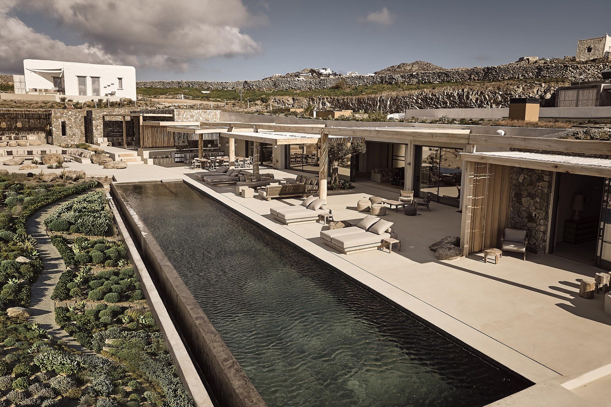 View of the swimming pool and lounging area at luxury villa rental Prestige