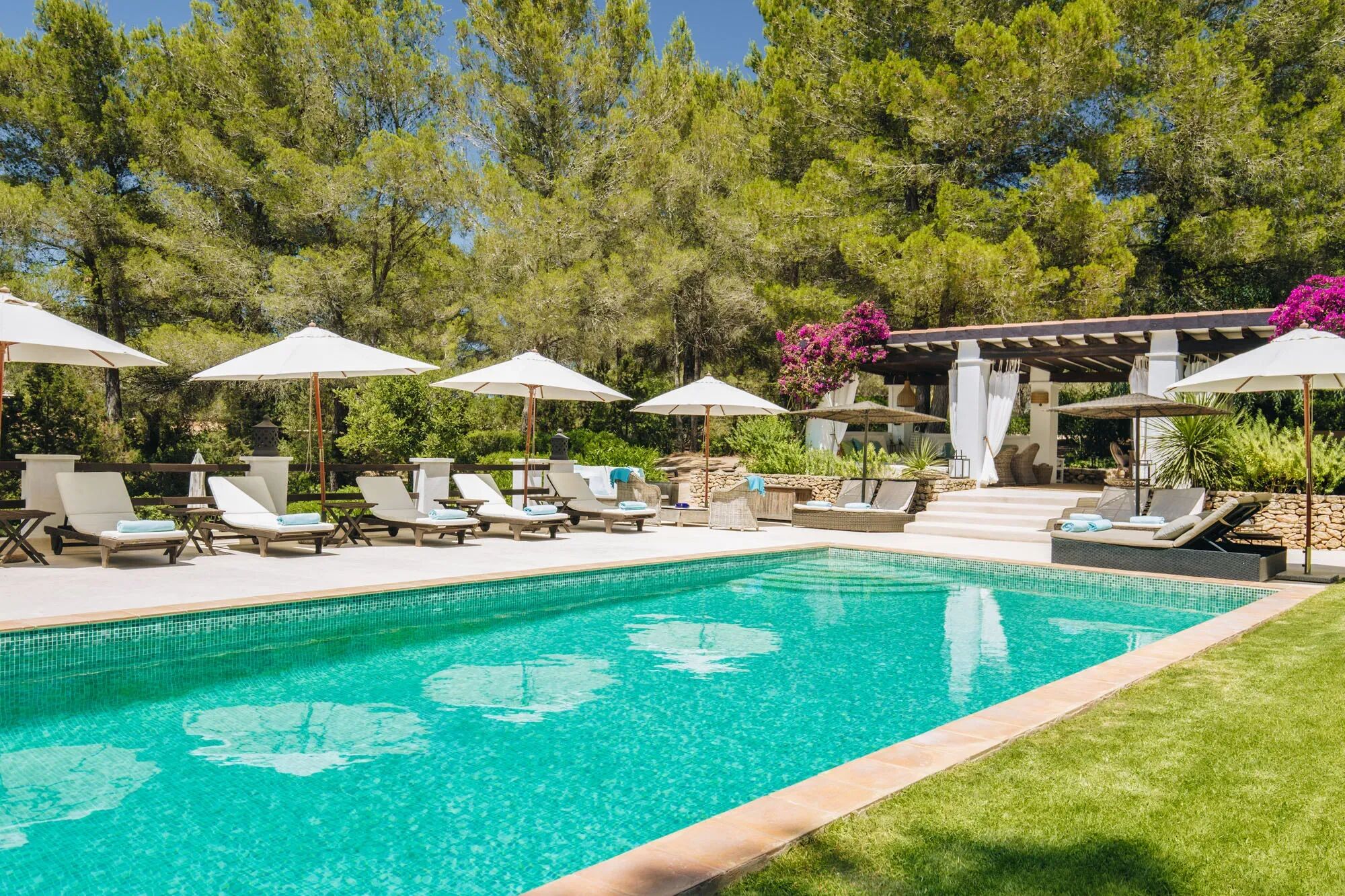 Swimming pool and sun loungers in the manicured gardens of Villa Charo