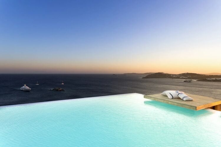 The infinity pool of Villa Muse blending into the Aegean Sea in Mykonos