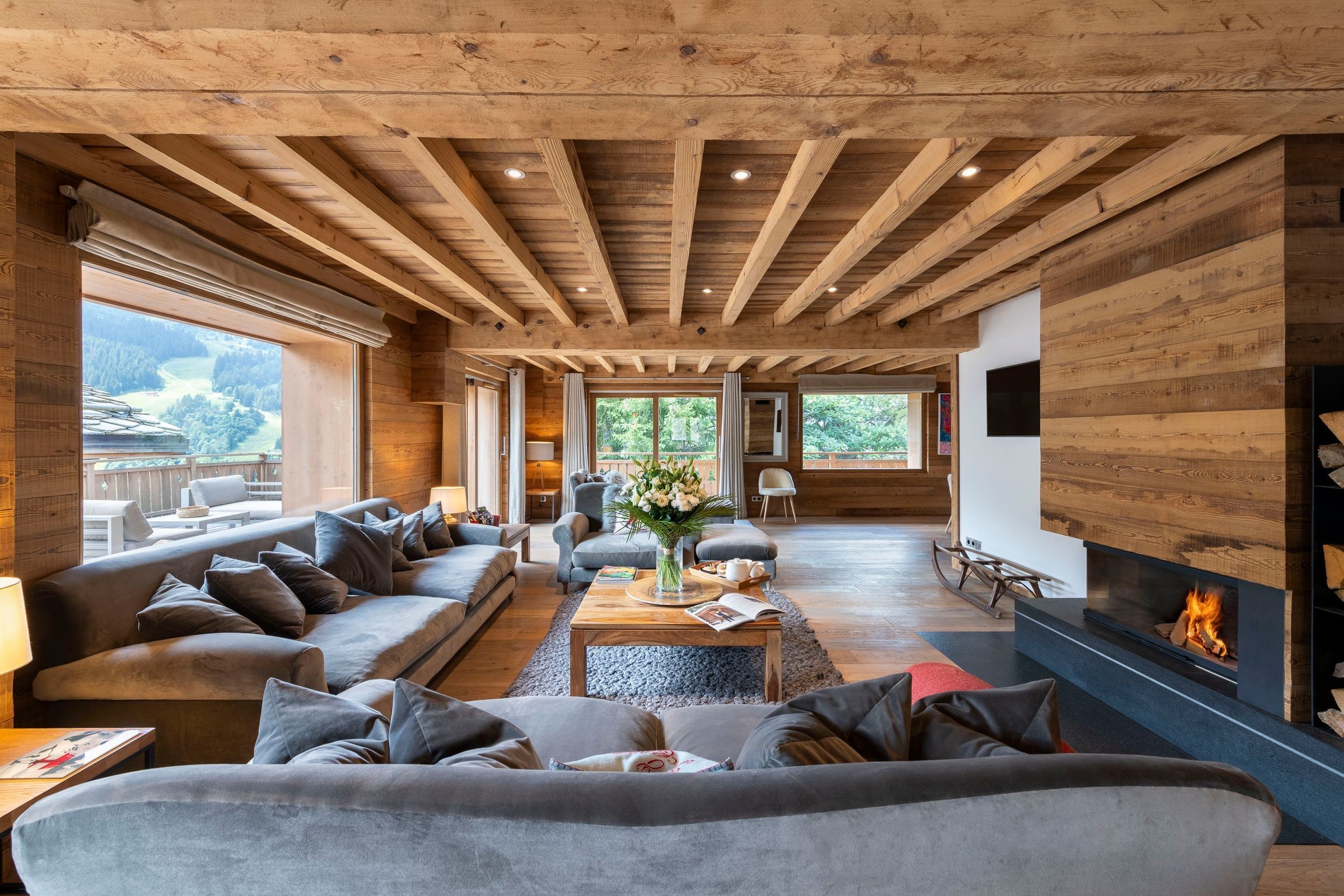 Chalet La Folie's living space with fireplace and valley views – luxury ski chalet in Méribel