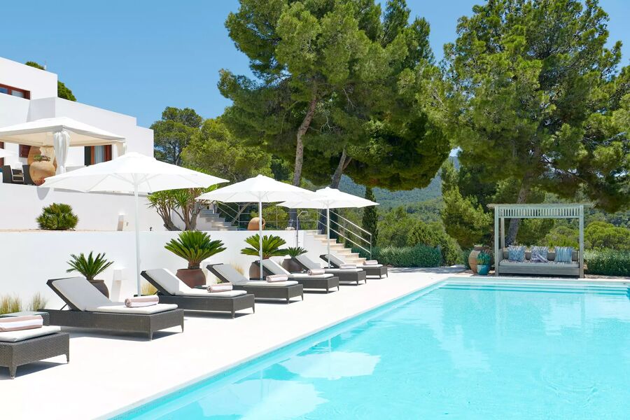 Poolside at Villa Aleni with the sunloungers and umbrellas perfectly position at this luxury rental villa