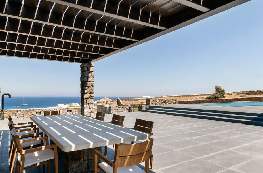 The shaded alfresco dining space near the pool and incredible views of the Mediterranean Sea  at luxury rental Villa Manifica