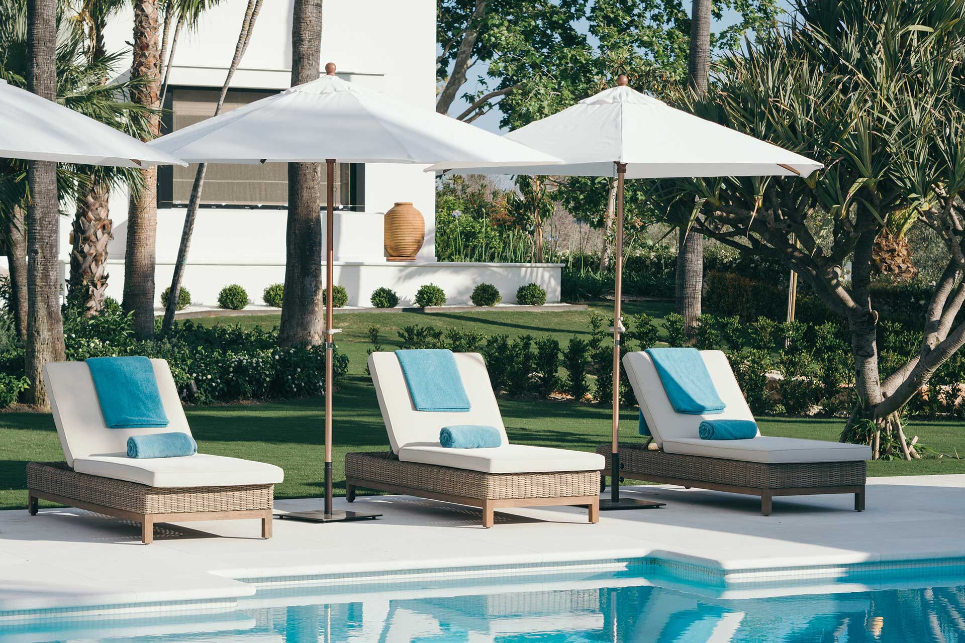 Sun loungers around the pool at Villa Jazmin in Marbella.