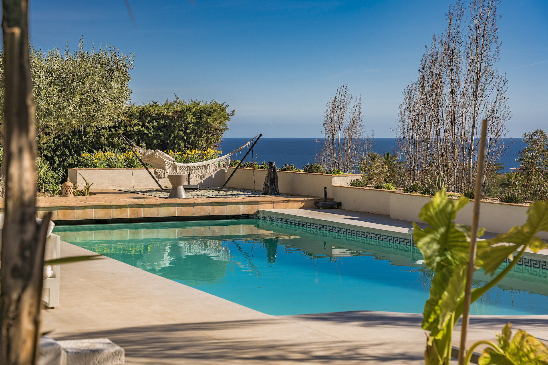 Secluded saltwater pool at Villa Amelia with hammock and panoramic sea views, ideal for tranquil outdoor living in the French Riviera