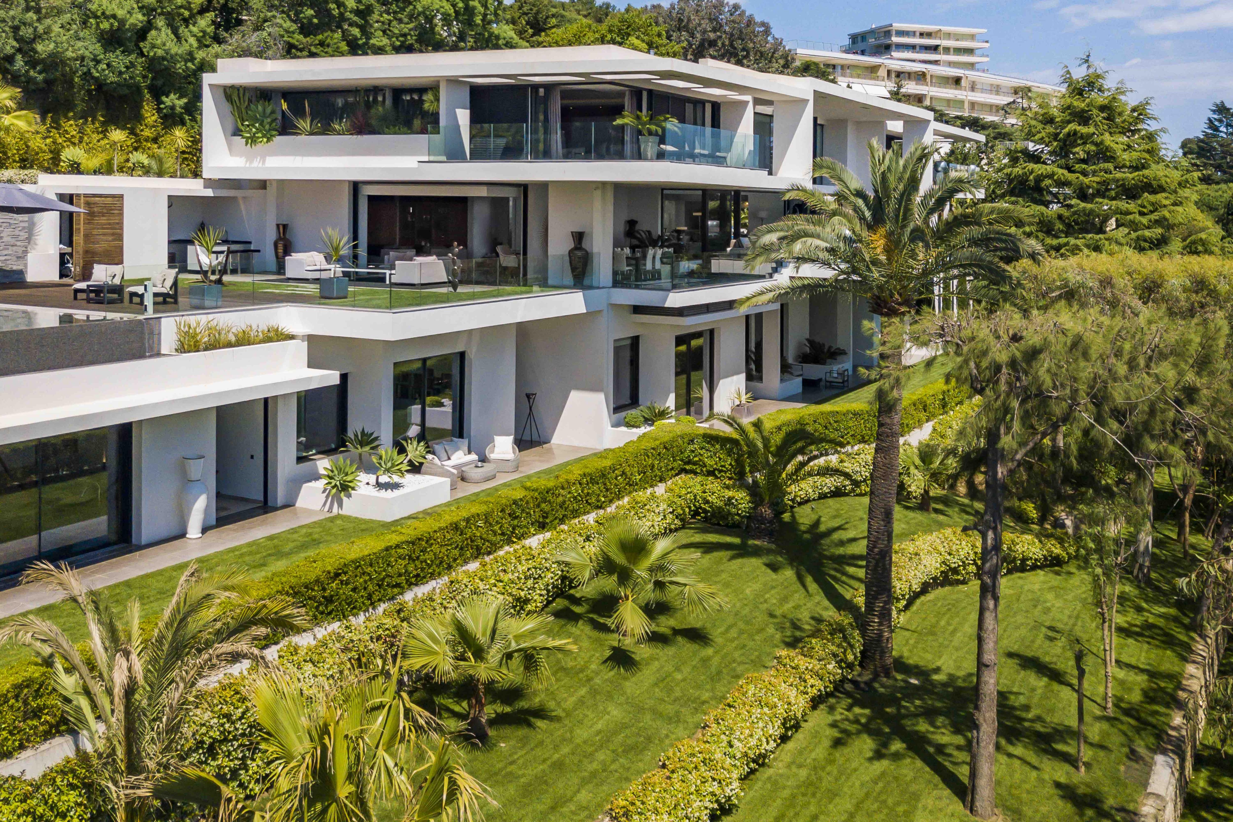 Elevated view of Villa Cassiopeia’s terraced layout and manicured grounds, offering expansive outdoor living spaces and Mediterranean vistas