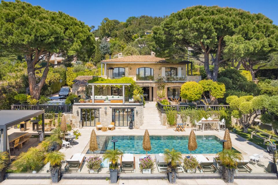 Stone-built Villa Emma in La Croix des Gardes with tiered terraces, lush gardens, and a private pool surrounded by shaded loungers