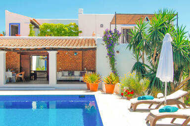 Poolside at Can Bab in Ibiza with beautiful sunbeds and gorgeous plant life
