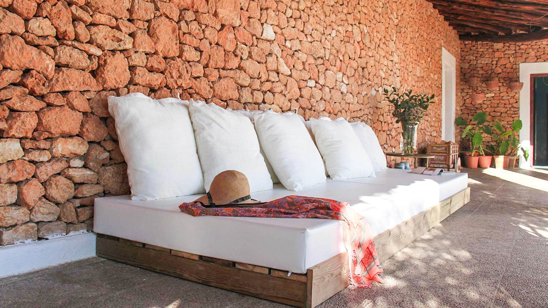 Shaded seating in the exterior of Can Bab in Ibiza with plush seating