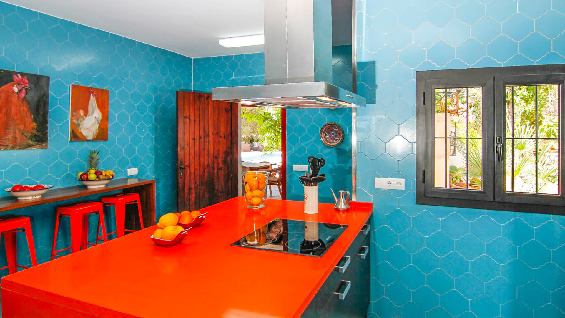 The uniquely blue and red kitchen in Can Bab in Ibiza with breakfast bar