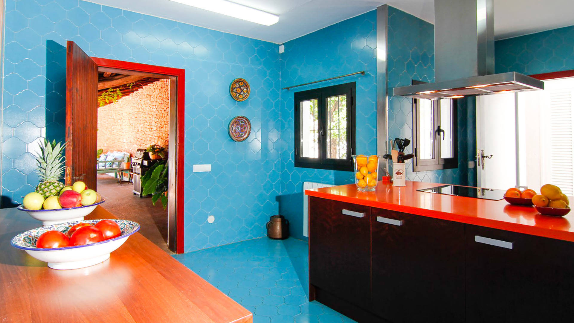 The contrasting red and blue kitchen in luxury vacation rental Can Bab in Ibiza