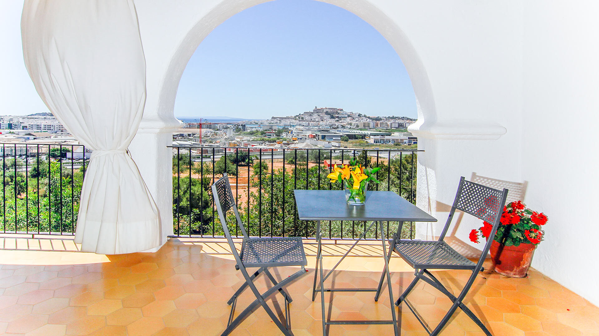 Shaded balcony at Can Bab in Ibiza with a small table and chairs to enjoy a quiet breakfast