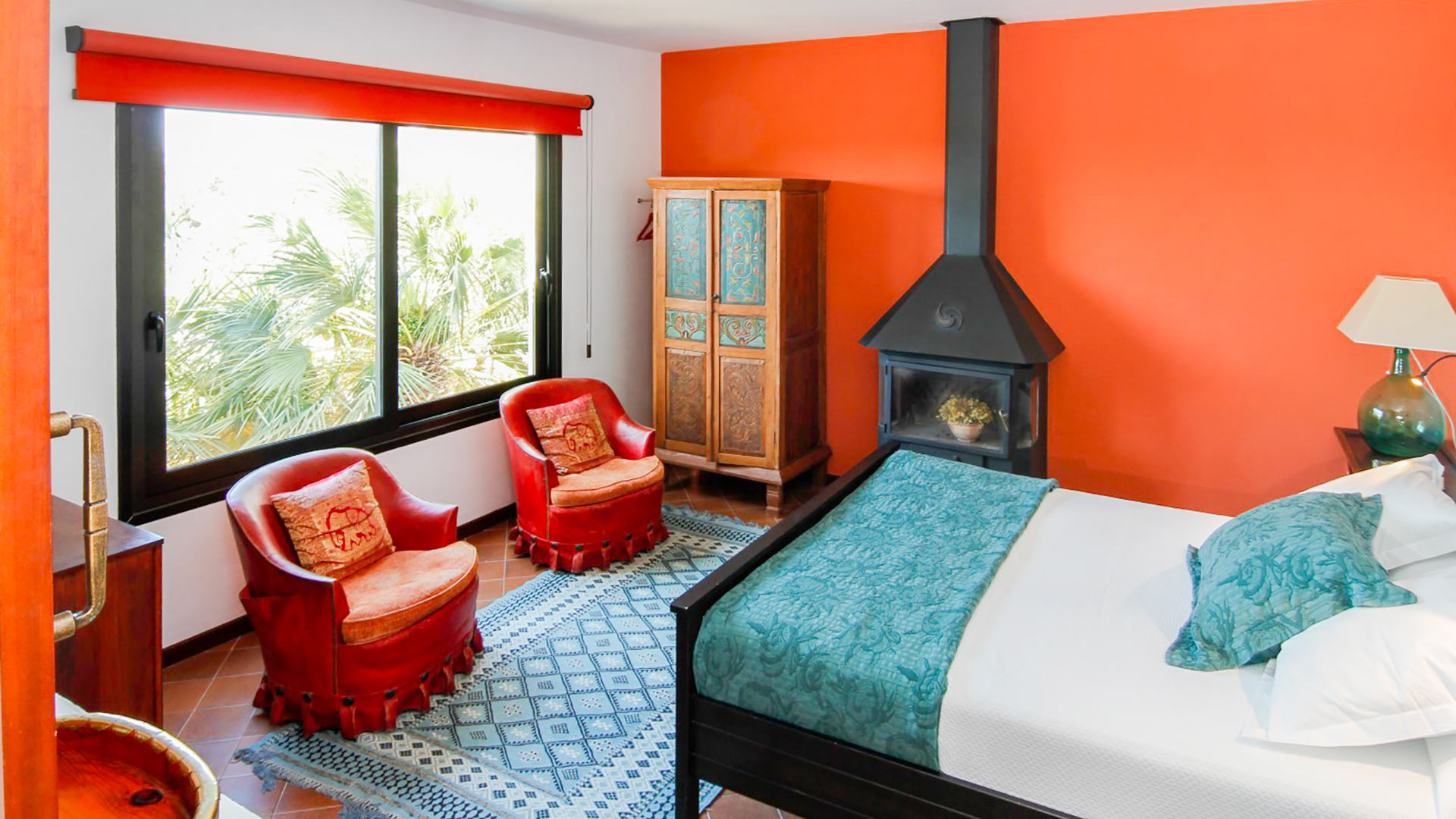 One of the large bedrooms in Can Bab in Ibiza with a beautiful view and plush chairs to relax in