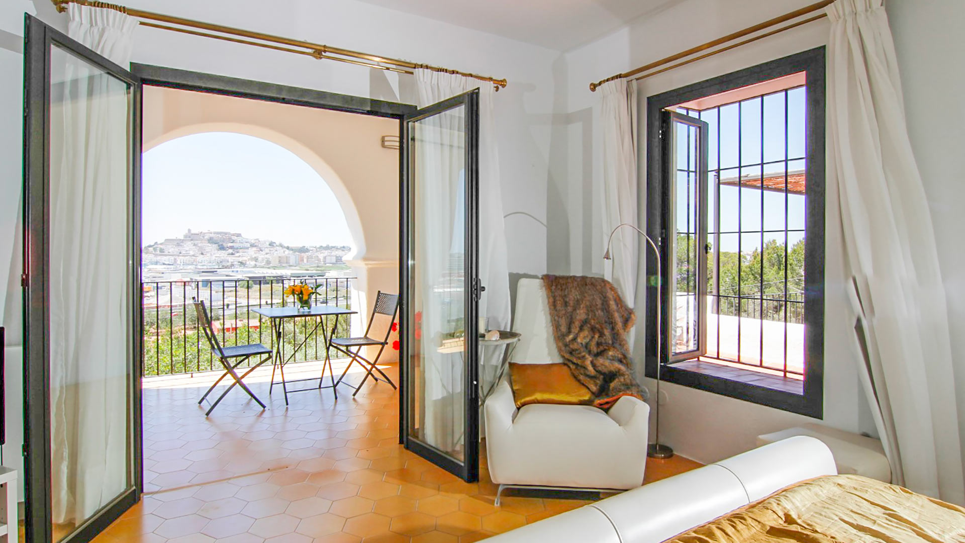 Natural sunlight beaming in at villa rental Can Bab in Ibiza with open patio doors onto sun-kissed balcony