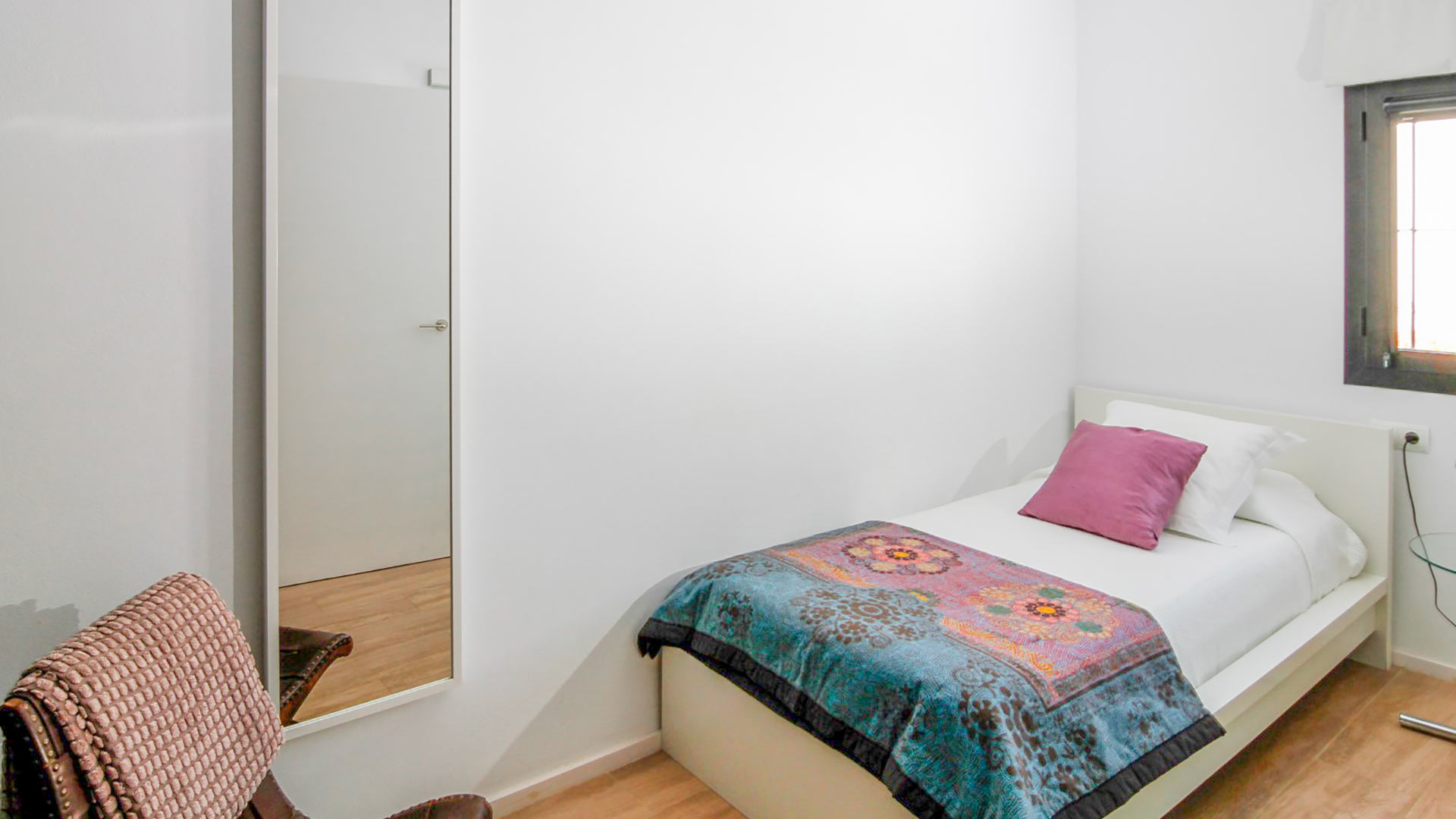 One of the bedrooms in Can Bab in Ibiza with a cool tone interior palette
