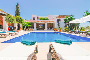 Swimming pool view at Can Bab in Ibiza headed by the pergola