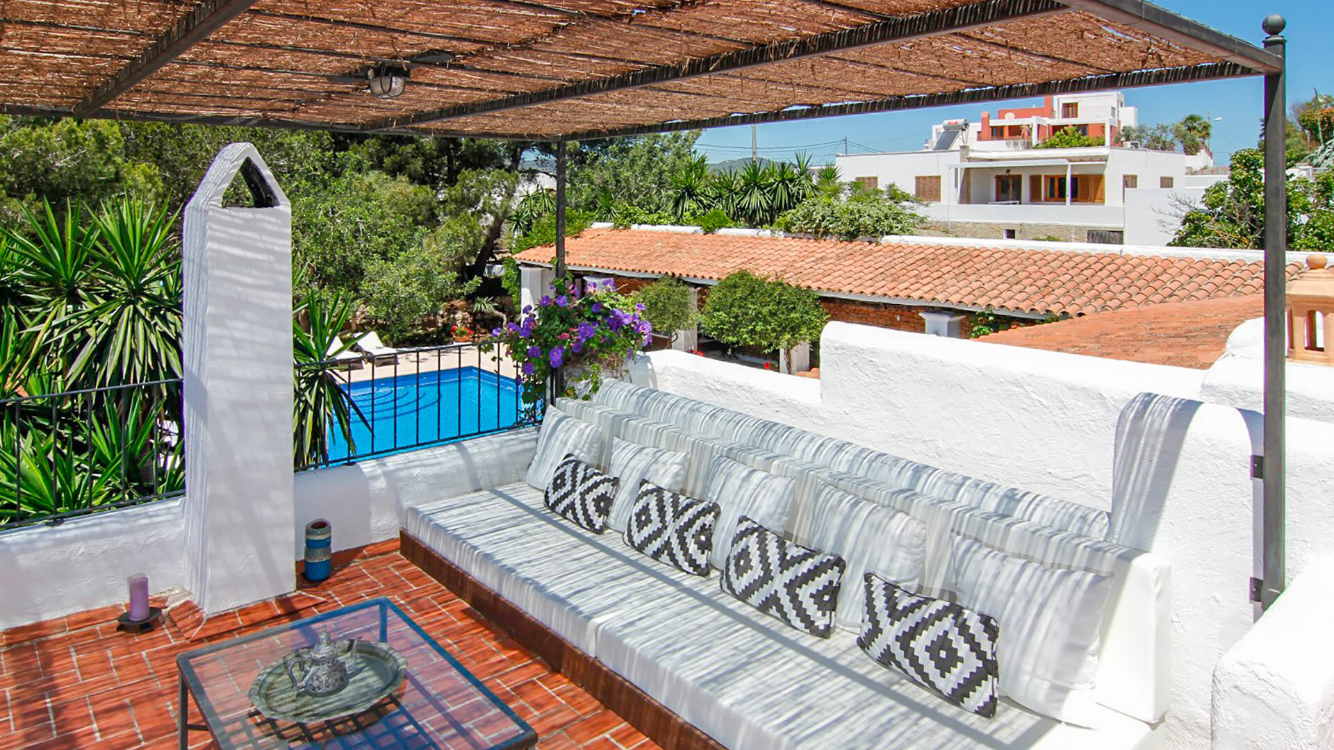 Shaded rooftop pergola at Can Bab in Ibiza with inviting seating