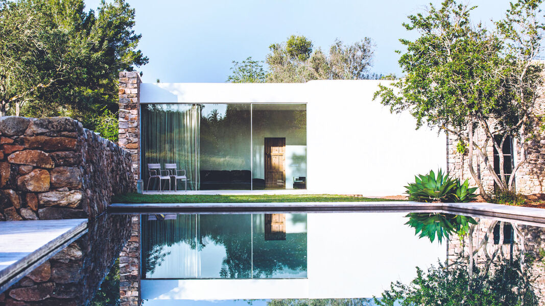 Villa Can Basso in Ibiza's swimming pool and the a view into the living space from outside