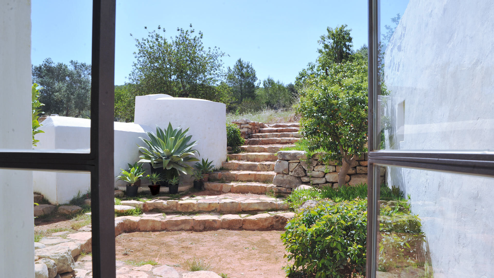 Stone pathway leading to the gardens from Villa Can Basso in Ibiza