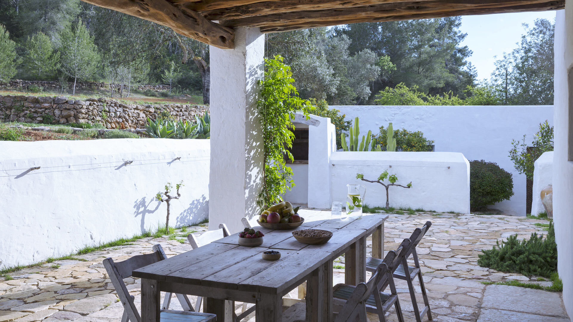 Luxury villa rental Can Basso's pergola covered table ideal for families and large gatherings