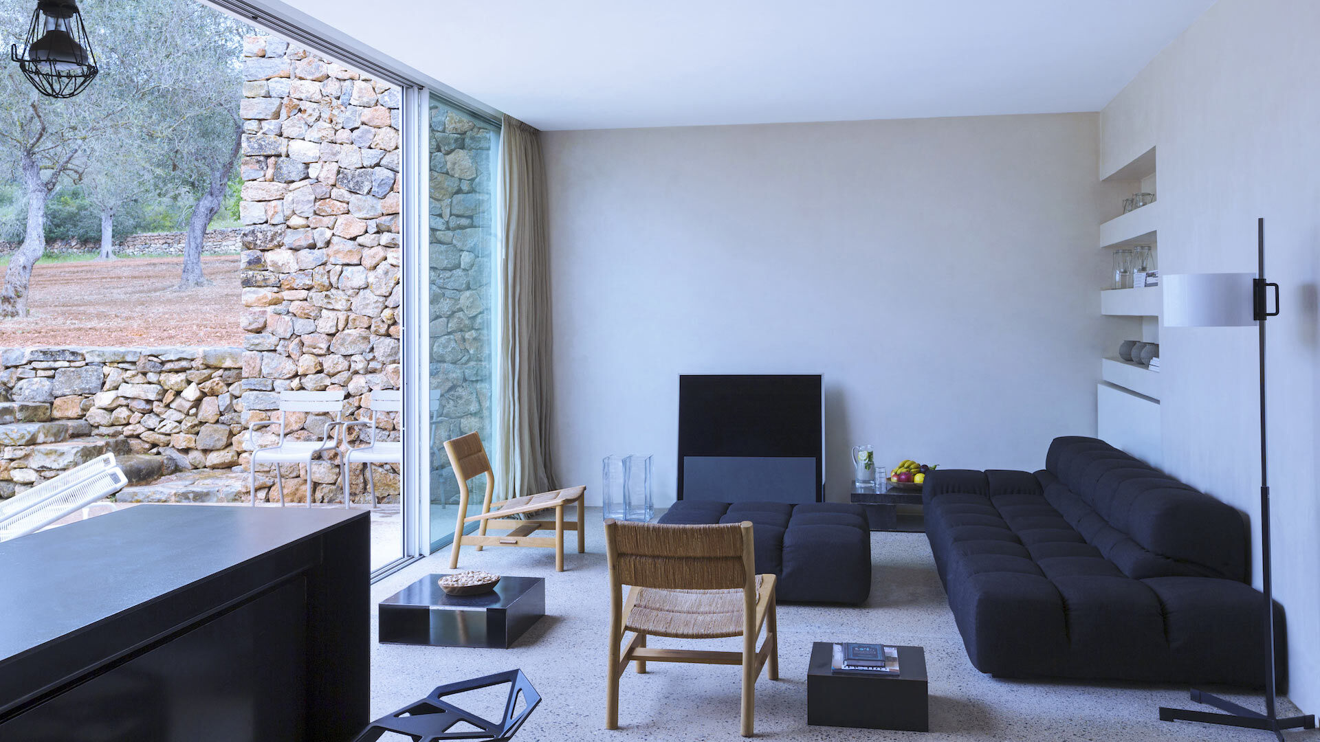 The living space with comfortable seating & floor to ceiling French doors opened to outside at Villa Can Basso in Ibiza