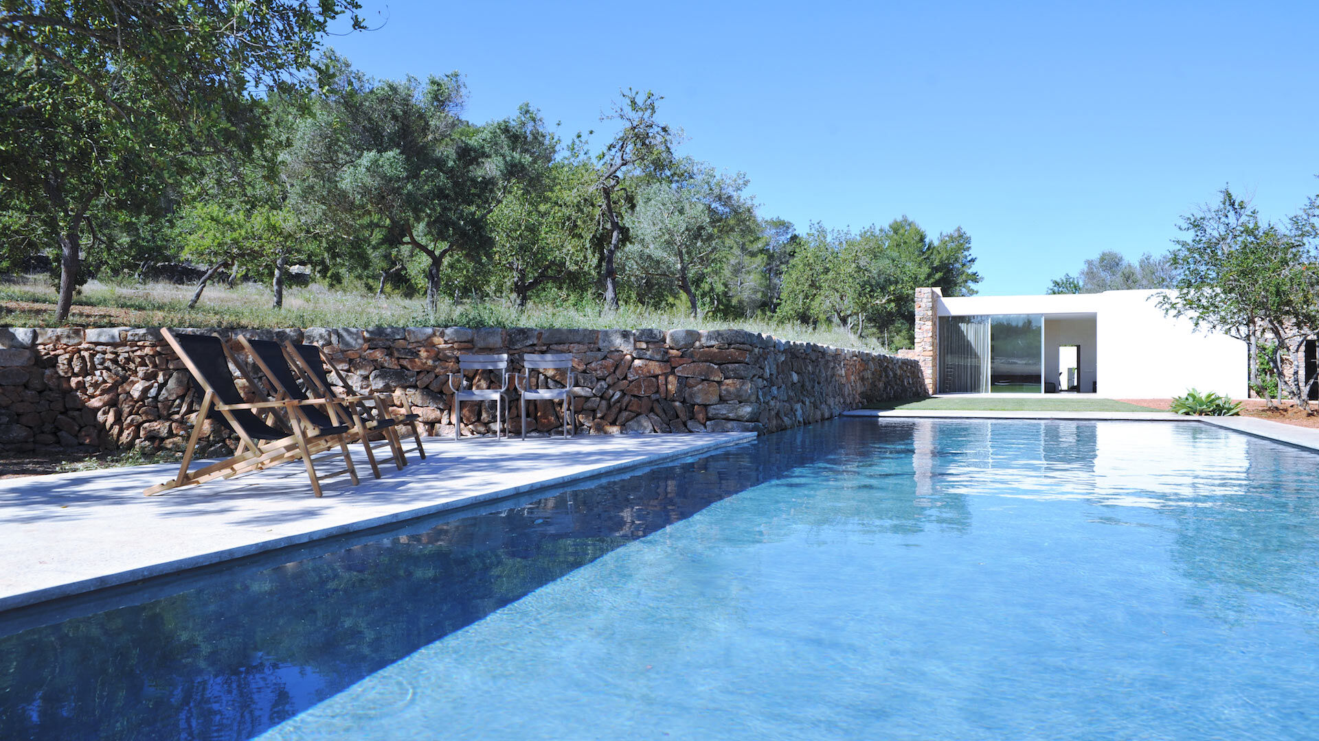 The crystal clear blue swimming pool at Villa Can Basso in Ibiza