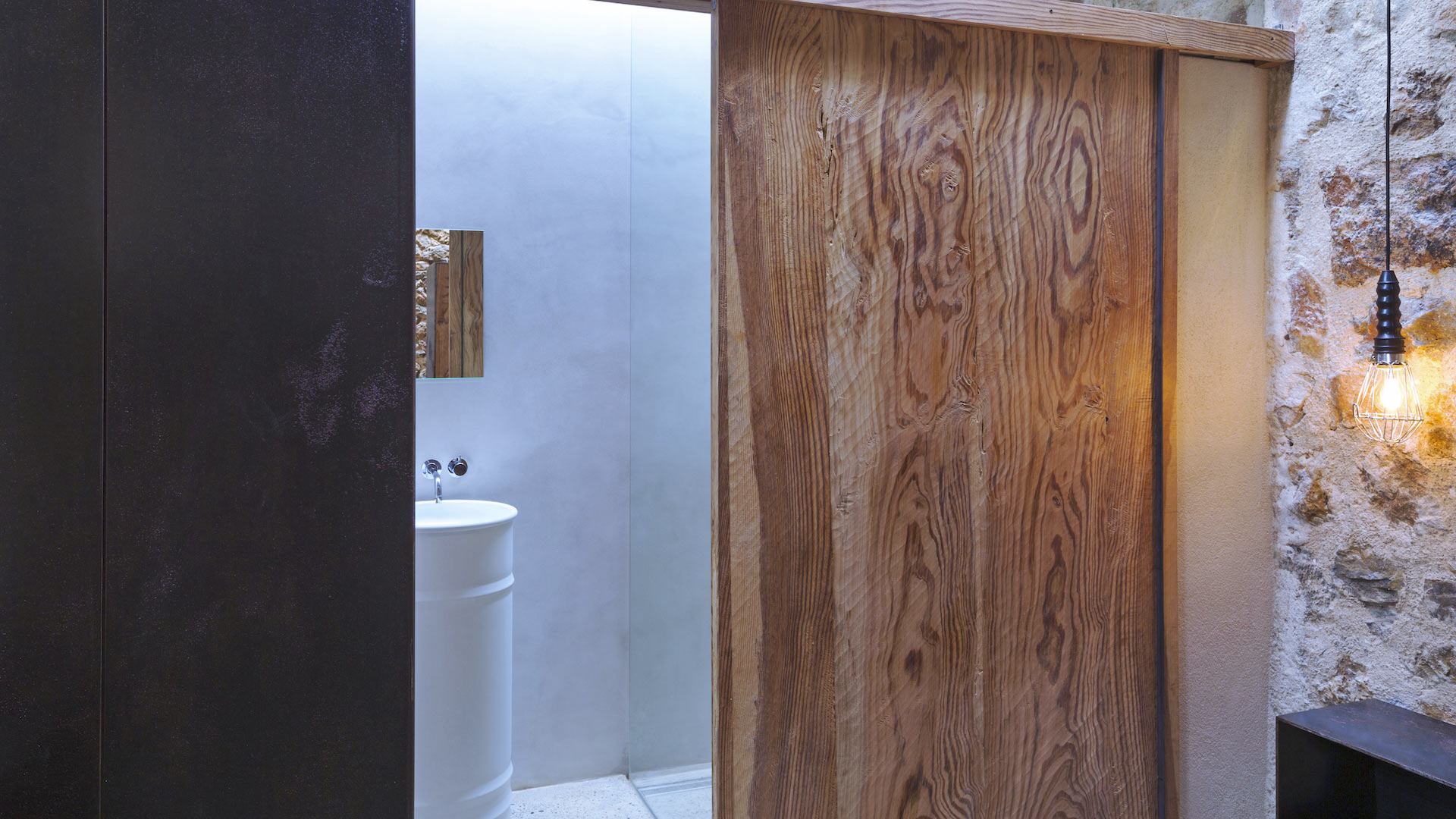Opened sliding door into the ensuite of one bedroom from Villa Can Basso in Ibiza