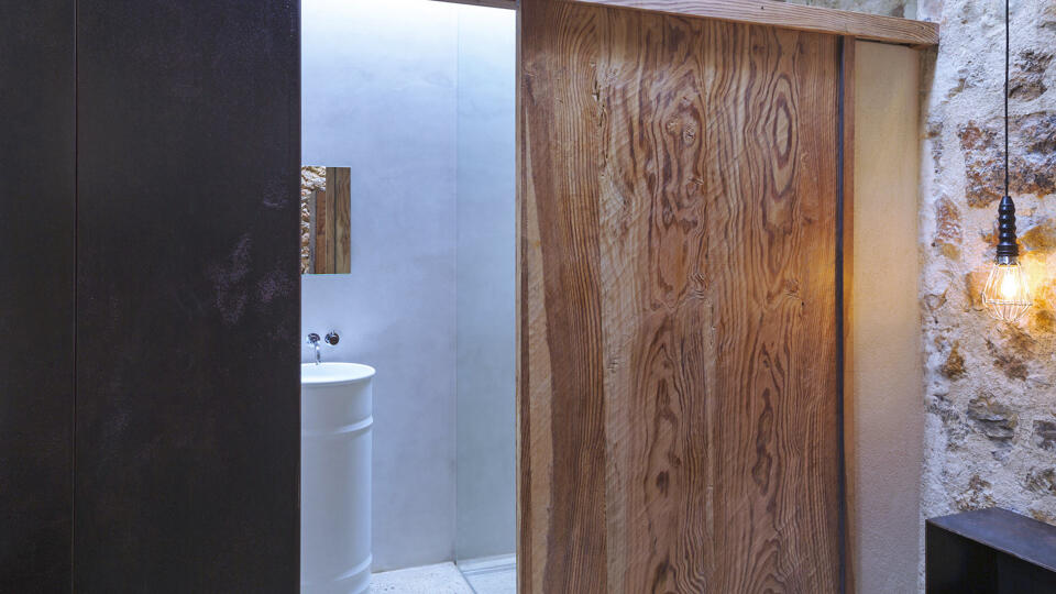 Opened sliding door into the ensuite of one bedroom from Villa Can Basso in Ibiza