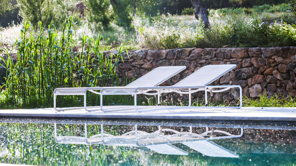 Sunloungers next to the beautiful pool in the serene Villa Can Basso in Ibiza