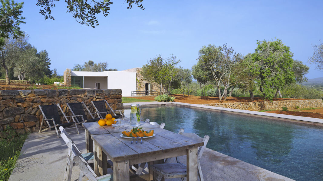 Full view of the swimming pool and luxury Villa Can Basso in Ibiza