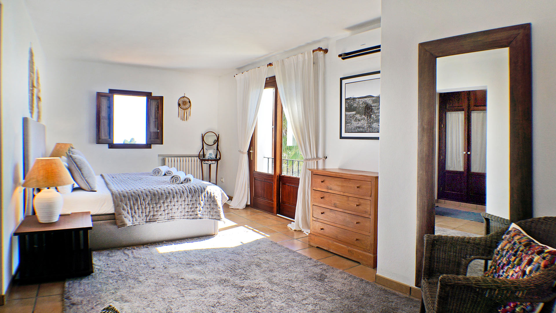 One of the large bedrooms in Can Selena with beautiful patio doors in Ibiza