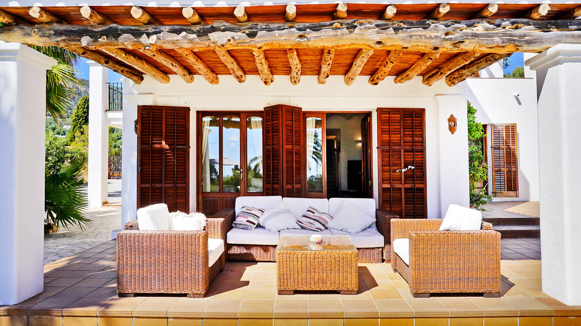 The shaded pergola with plenty of sunloungers and seating in the luxury villa rental Can Selena in Ibiza