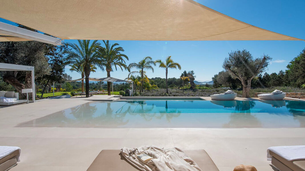 Lagoon style swimming pool at Villa Casa Isa in Ibiza with shaded awning