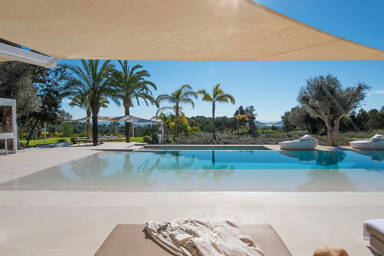 Lagoon style swimming pool at Villa Casa Isa in Ibiza with shaded awning