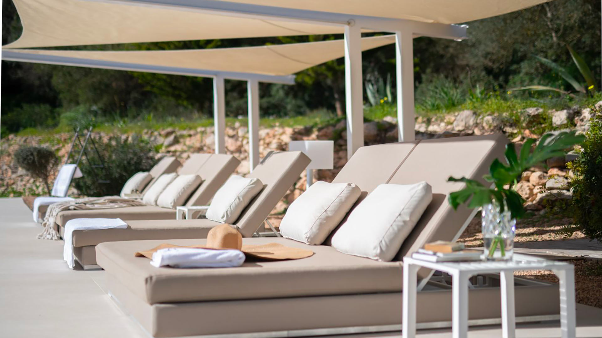 The sunbeds around the pool at luxury villa rental Casa Isa