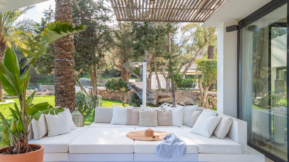 Large comfortable white seating area under a shaded awning at Villa Casa Isa in Ibiza