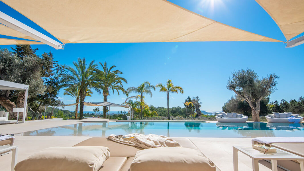 Shaded sun lounging areas at Villa Casa Isa in Ibiza by the pool