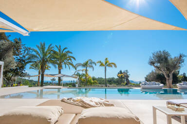 Shaded sun lounging areas at Villa Casa Isa in Ibiza by the pool