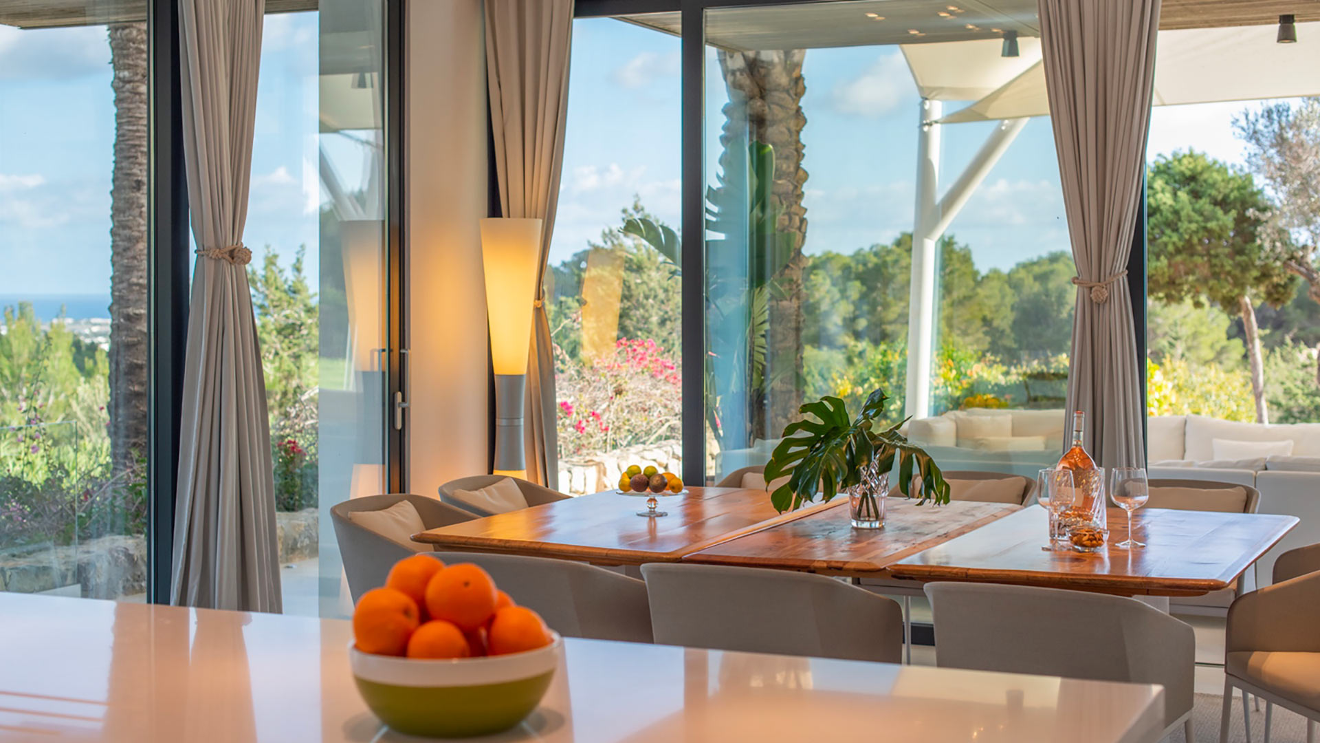 The dining area with floor to ceiling windows showcasing the best of Ibiza from Villa Casa Isa