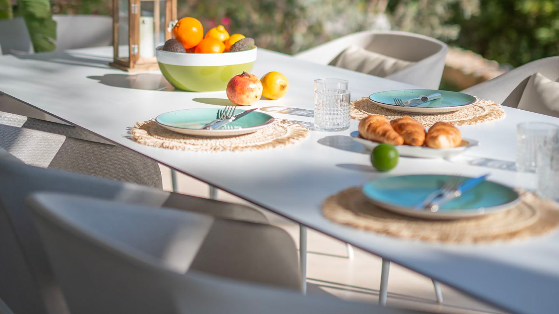 Alfresco dining set up with croissants and various fruits scattered about Villa Casa Isa in Ibiza