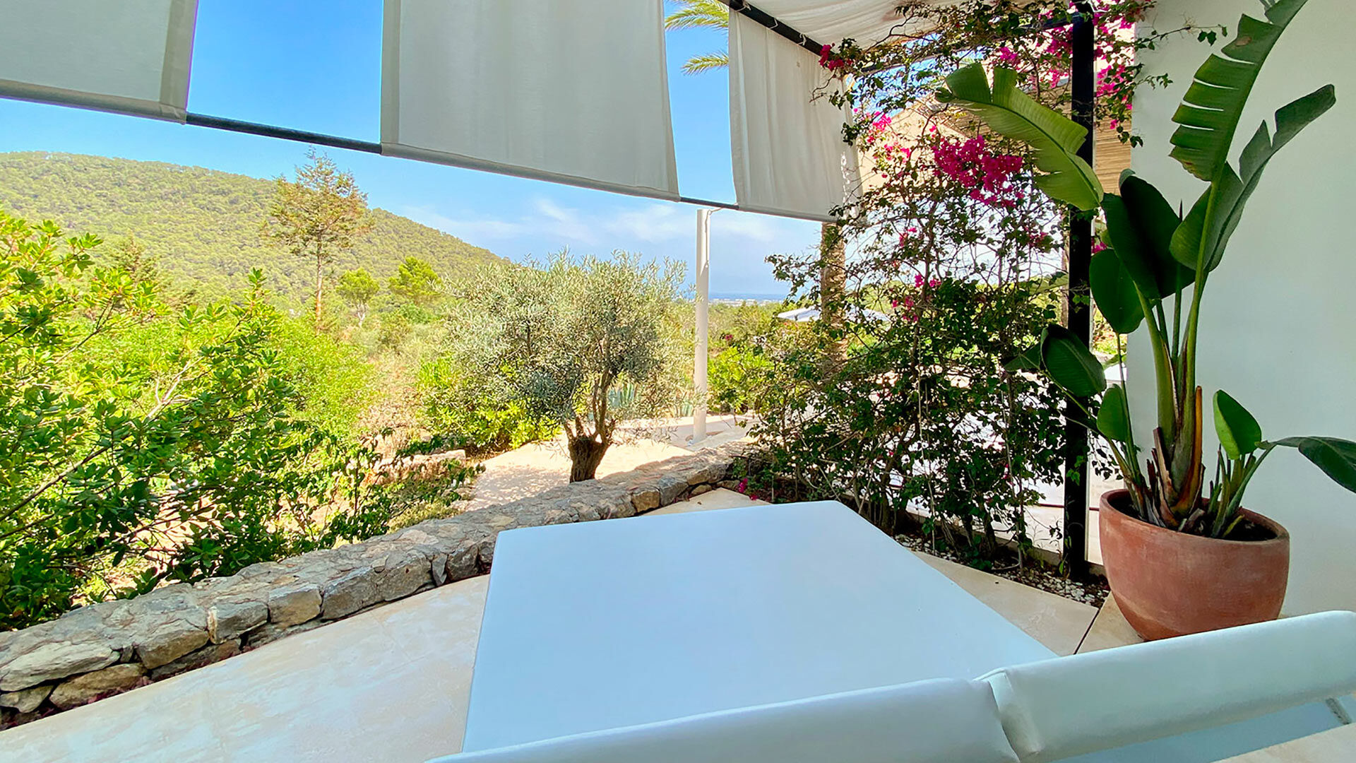Private shaded patio for one of the guests with sunloungers at Villa Casa Isa in Ibiza