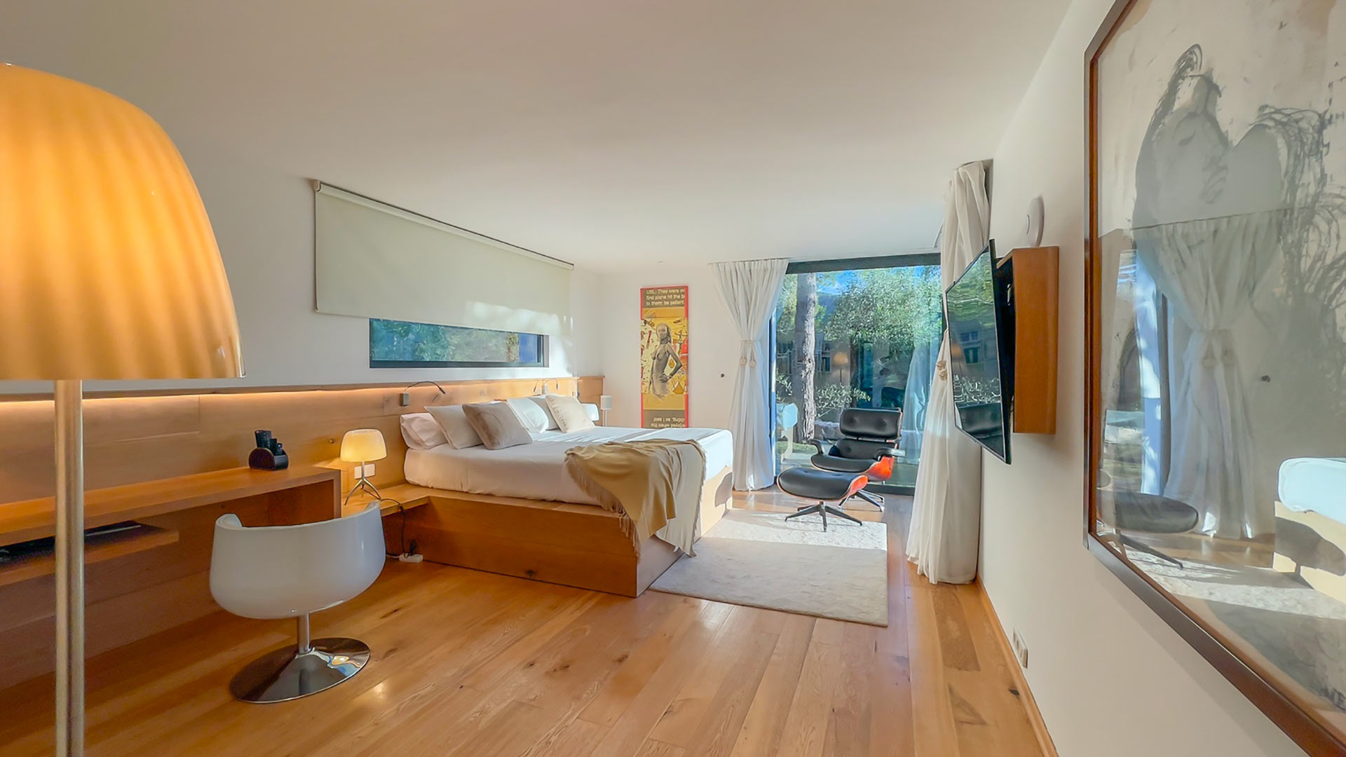 One of the large bedrooms with patio doors and office desk at Villa Casa Isa in Ibiza