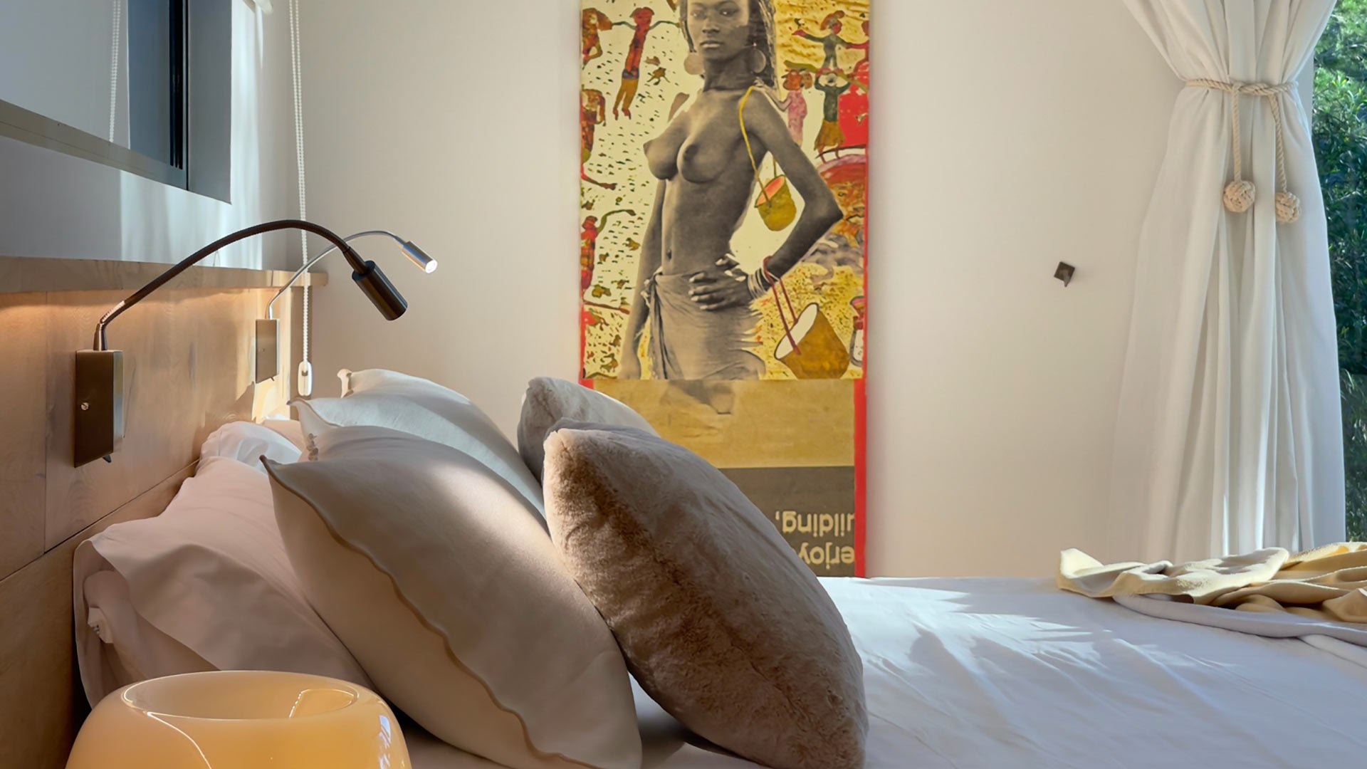 Close up of one of the beds in the large bedrooms and the art in the background Villa Casa Isa in Ibiza