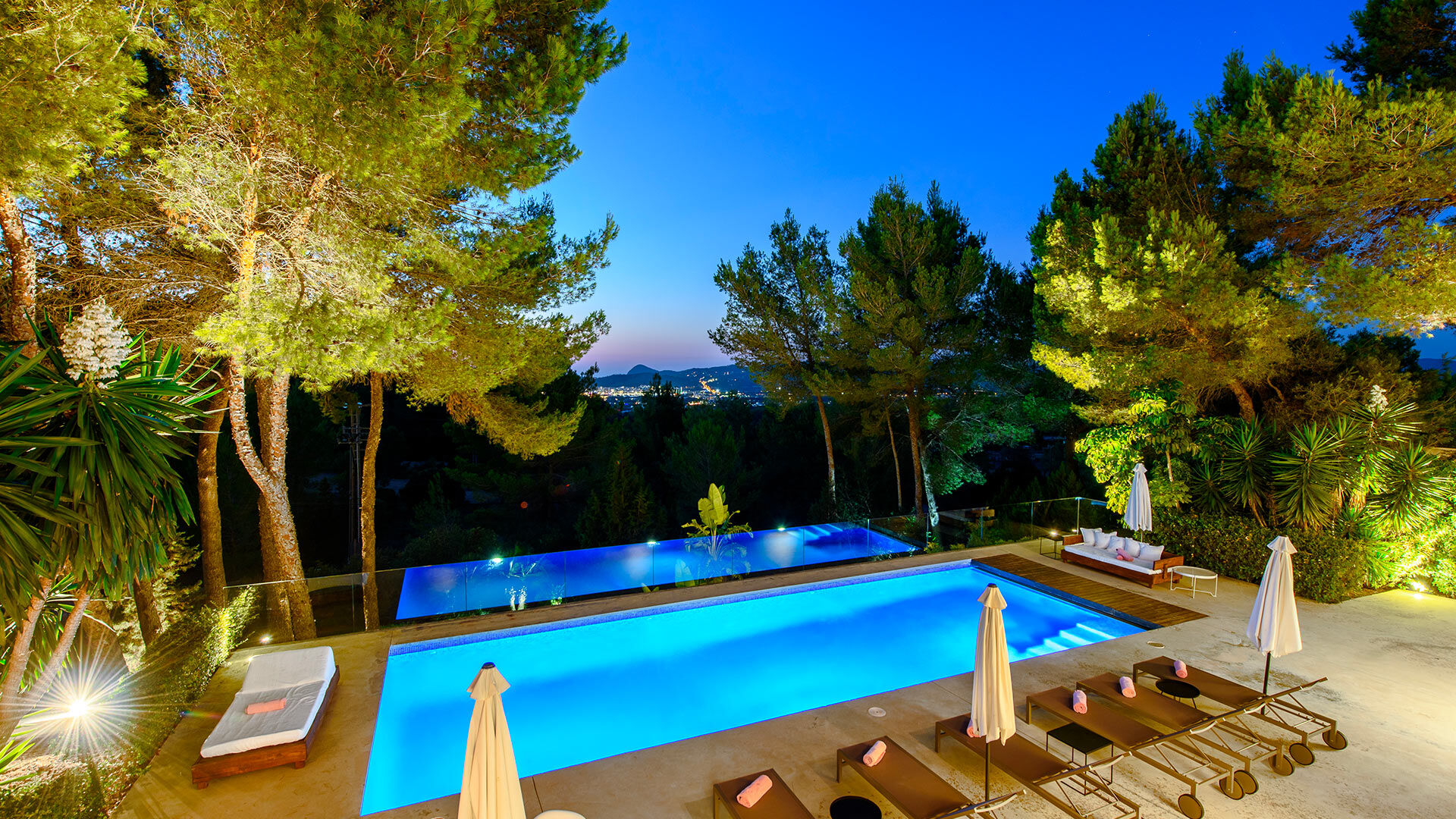 Nighttime shot of the gardens of luxury Villa Fabrik in Ibiza