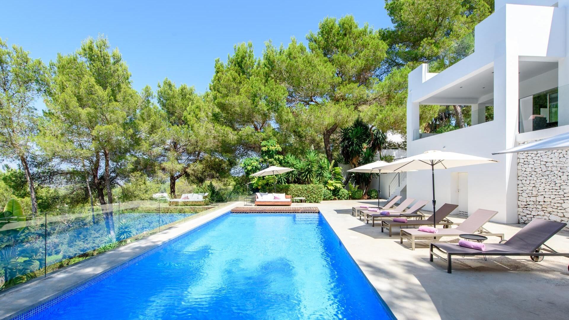 Poolside at Villa Fabrik in Ibiza with beautiful powder pink sunloungers