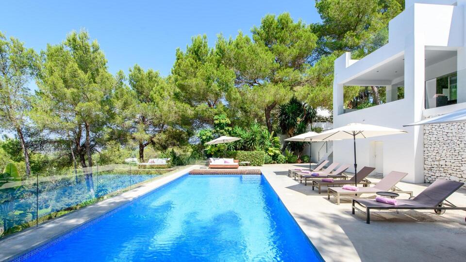 Poolside at Villa Fabrik in Ibiza with beautiful powder pink sunloungers