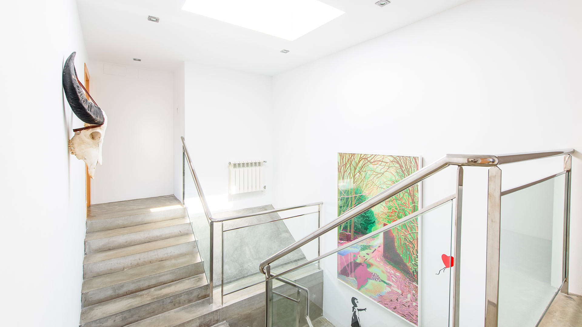 Artwork covered hallway walls of Villa Fabrik in Ibiza