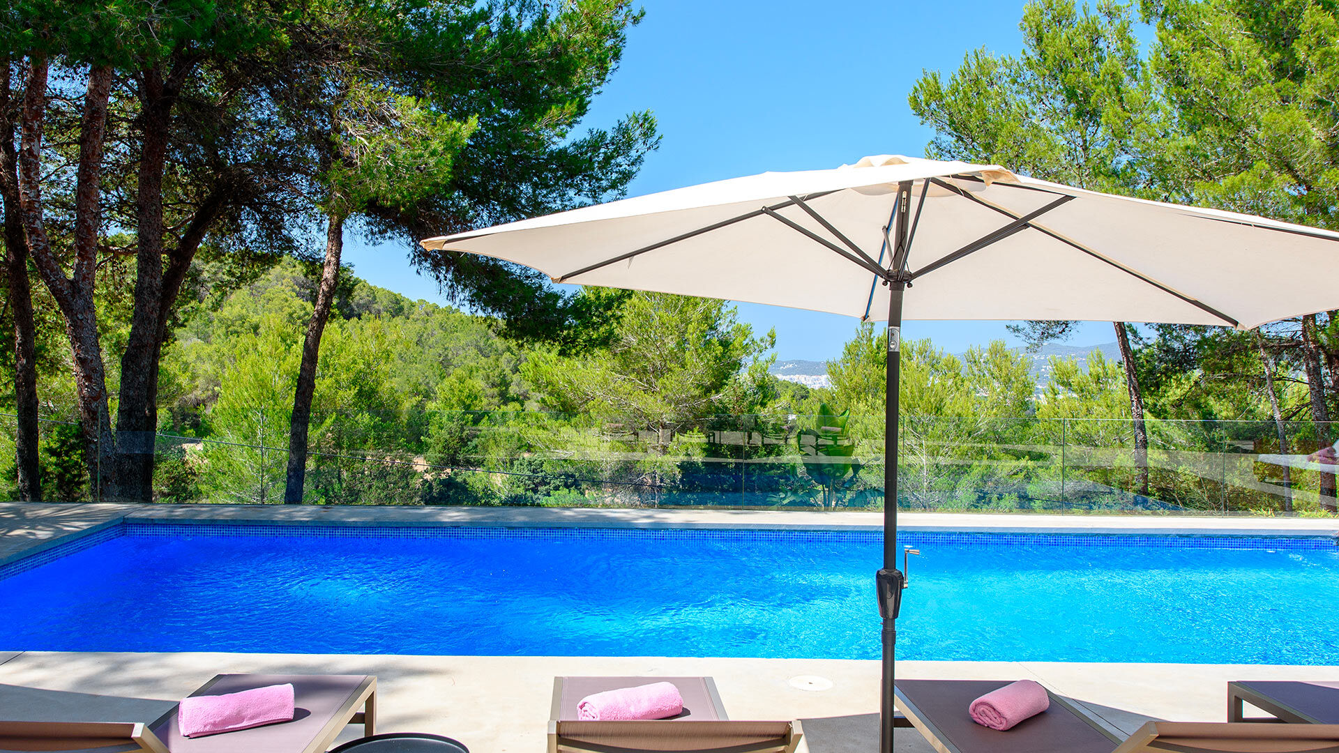 Sunbeds around the swimming pool in Villa Fabrik in Ibiza